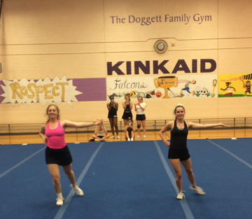 Grace Nevil (11) and Katlyn Feldman (10) preform the tryout dance at clinic.