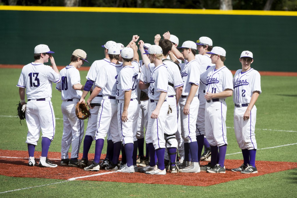 Baseball team comes in for a huddle before the game against Bishop Lynch.