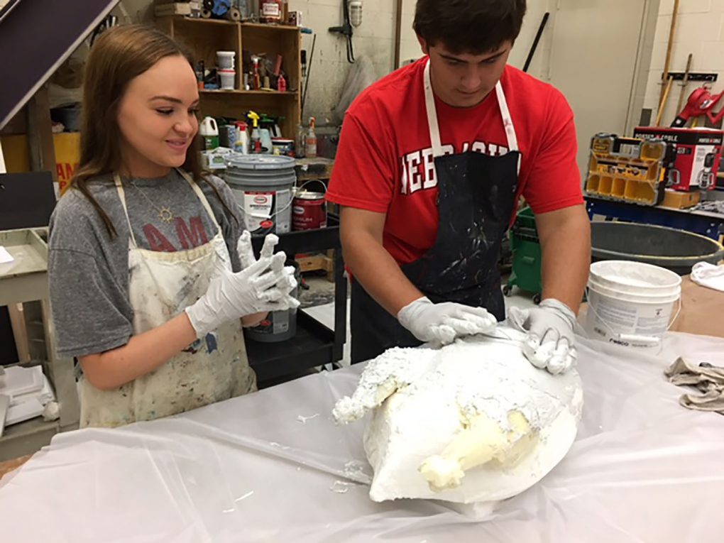 Elizabeth Mitchell (12) and Michael Horne (11) work on props. 