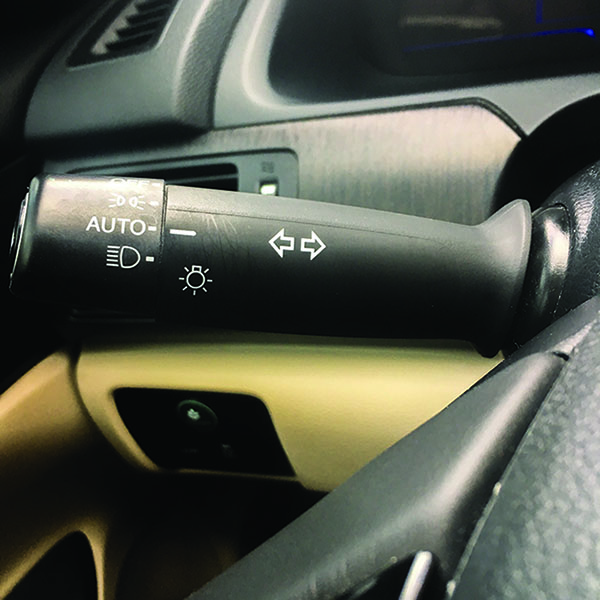 This lever (located to the left of the steering wheel) controls the turn signals on a car. Gently push the lever up to indicate a right turn, or push down to indicate a left turn.