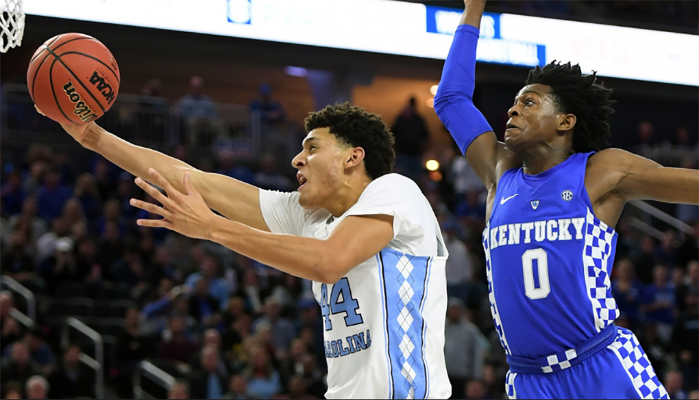 North Carolina’s Justin Jackson flies past Kentucky’s De’aaron Fox while attempting a layup on December 17th. (Photo by Ethan Miller)