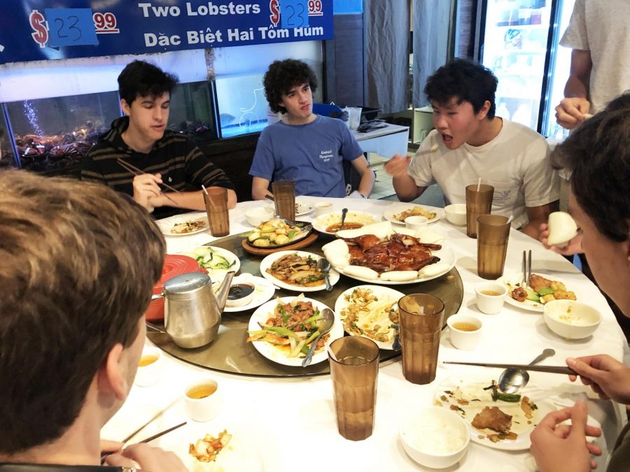 Juniors Martin Ibarra, Duncan Lambert and Elliot Ly enjoy a hefty meal of Chinese cuisine with classmates during their field trip with the Chomping Down in Chinatown class.