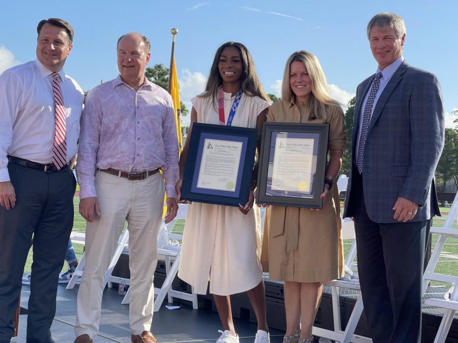 Head of School Jonathan Eades, Mayor of Piney Point Mark Kobelan, Olympic Medalist Raevyn Rogers '14, Olympic Coach Megan Watson, and Athletic Director David Holm pose for a picture.  
