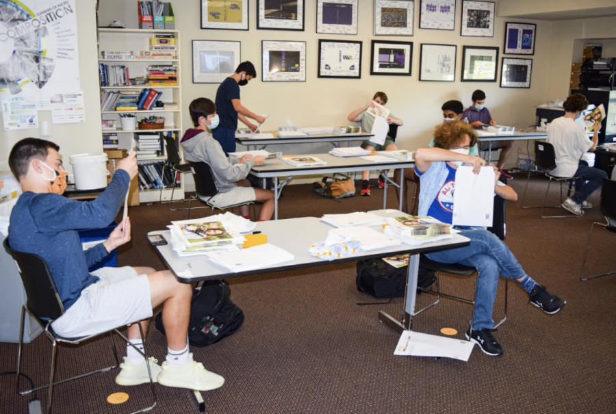 Students in G-period journalism examine spread designs.