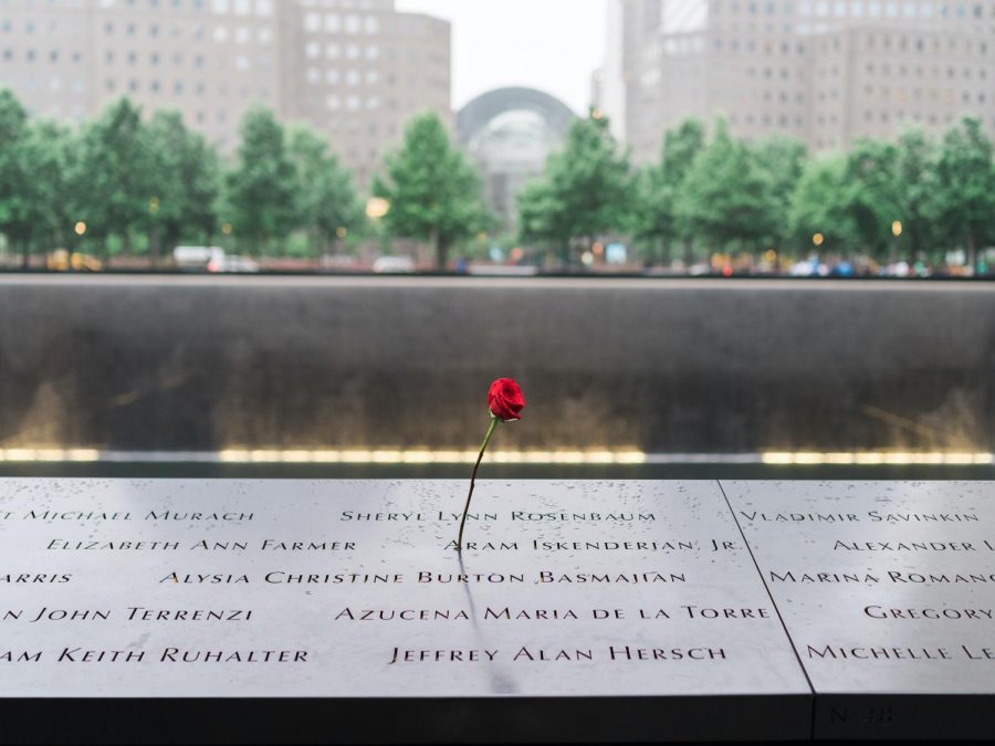 A red rose on a tomb next to the fallen Twin Towers.