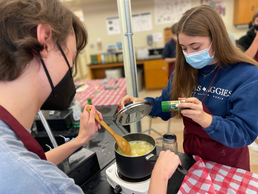 Juniors Jack Lemon and Taylor McMullen are finishing up their potato leek soup by adding spices during their Cooking 101 class