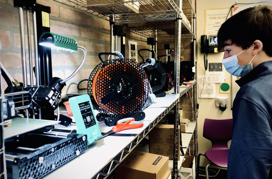 Ladin Strauss, a sophomore, watches a 3D printer hard at work.