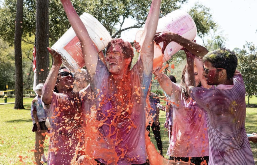 Students dunk buckets of water on one another during Holi.