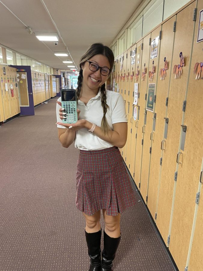 Senior Alice Ma poses with her calculator on Mock the Mavs day.