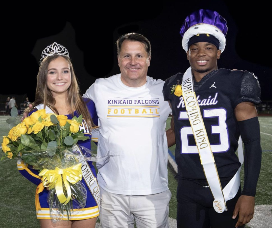 Homecoming king Micah Bell and queen Audrey Lobb smile with head of school Mr. Jonathan Eades after being crowned. 