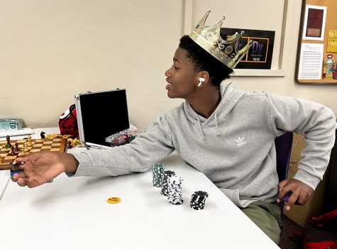 Freshman Crockett Berry hands out chips in a game of Crazy Eights. He was taking Game Master, a class taught by Upper School science teacher Ms. Kacie Horton during Interim Term.