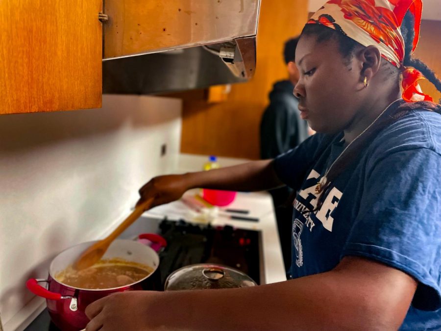 Sophomore Elizabeth Ajumobi stirs a pot of black-eyed peas while adding pepper as she makes a dish in the Beyond The Plate Interim Term class. Ajumobi often helped her mother cook traditional Nigerian food and breakfast for her entire family.
