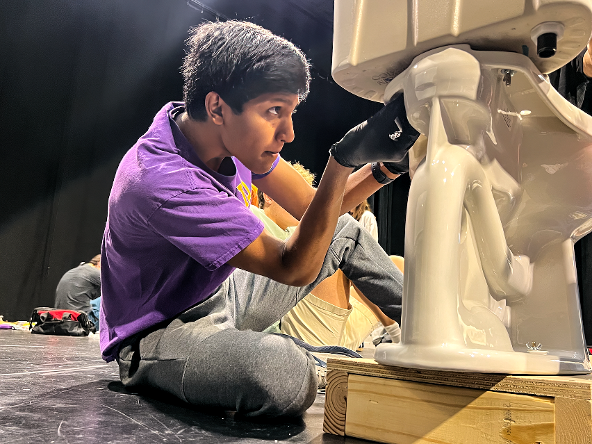 Junior Rohan Yalamanchili concentrates on tightening a screw on a toilet. Although this step only required the help of one person, Yalamanchili often worked partners. “There were certain parts in fixing the toilets that required the help of multiple people, so working together was essential," he said. "When one of us struggled with a step, then another member would often come help and bring in their own ideas.”