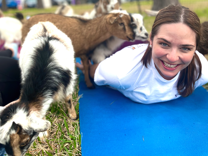 Ms. Lauren Stutts, Upper School science teacher and one of the teachers of Yoga and Wellness, strikes a yoga pose as goats gather around her. Smiles spread within the class as the goats made their way into the many yoga moves of students and teachers.

