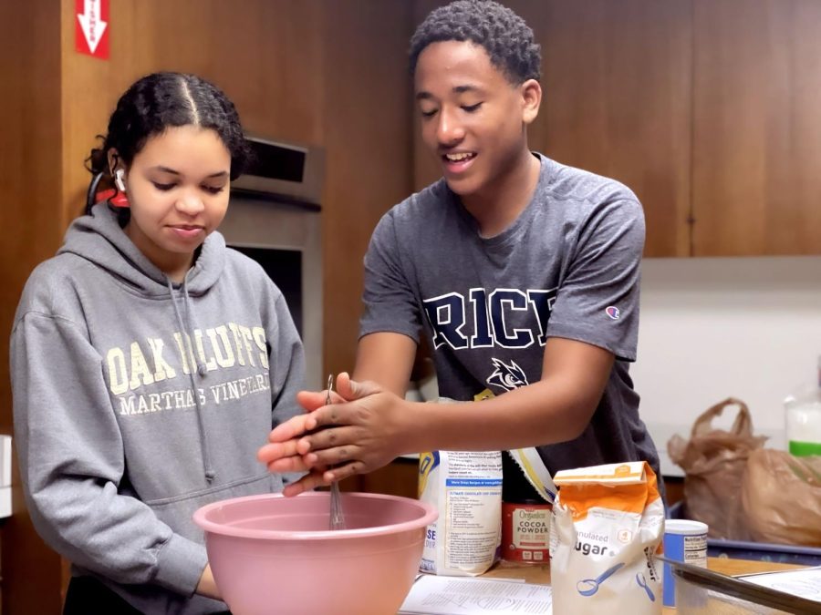 Sophomores Daniel Patterson and Ellie Bynam mix flour, sugar, salt and other ingredients. They prepared a traditional African pound cake in “Beyond The Plate.”
