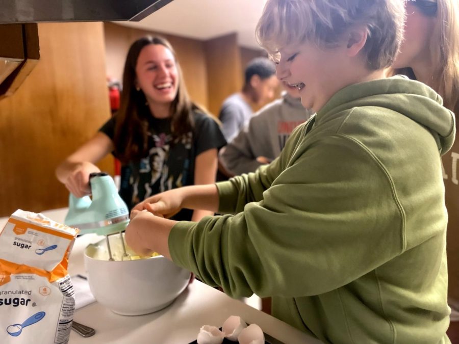 Sophomores Max Swanson and Maddy Billipp laugh while enjoying the “Beyond the Plate” class. Max added the eggs to the batter while Maddy mixed it. 
