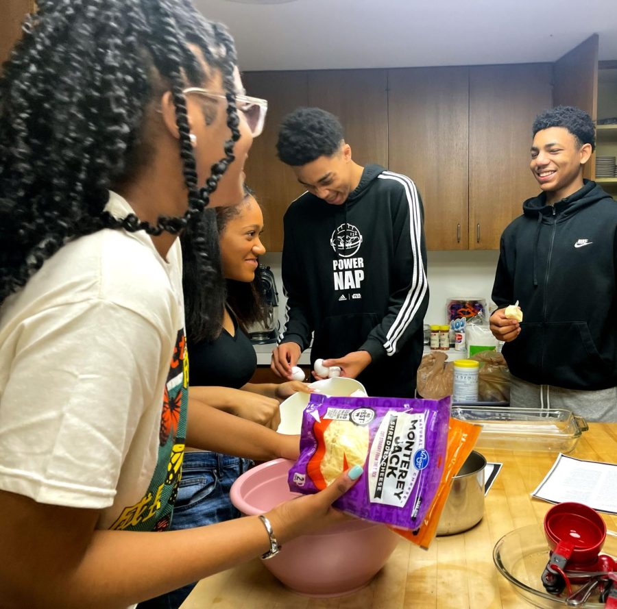 Sophomore Alyssa Latin, junior Rayya James, freshman Ethan Williams and sophomore Rob Satcher enjoy preparing the ingredients for mac and cheese. “This isn't the mac and cheese I know,” said Williams as he looked over the recipe. 
