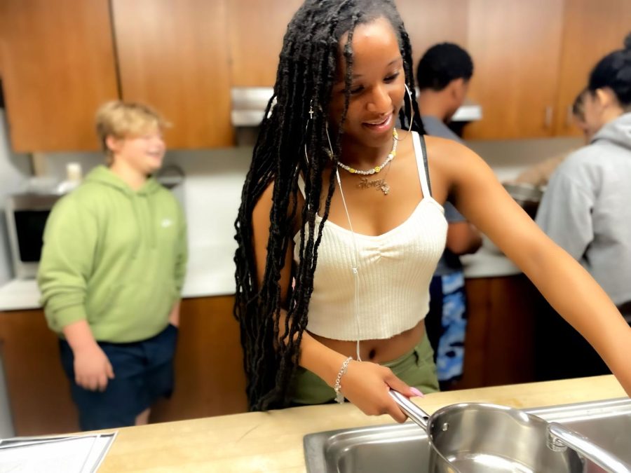 Sophomore Shelby Haskett pours water into a pot on the stove. The water was used for the noodles that would be a base for the  mac and cheese. 
