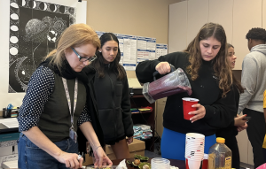 Ms. Forster helps students prepare their meals for their wellness project. 