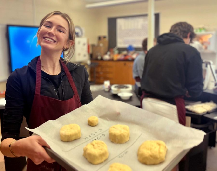 Anabelle Letzerich, a junior, looks forward to putting her creation into the oven. "I was so excited to see the results of all my class's hard work," Letzerich said  Once the dough took full form, each student put their biscuits onto a pan and they were prepared for baking in the oven.