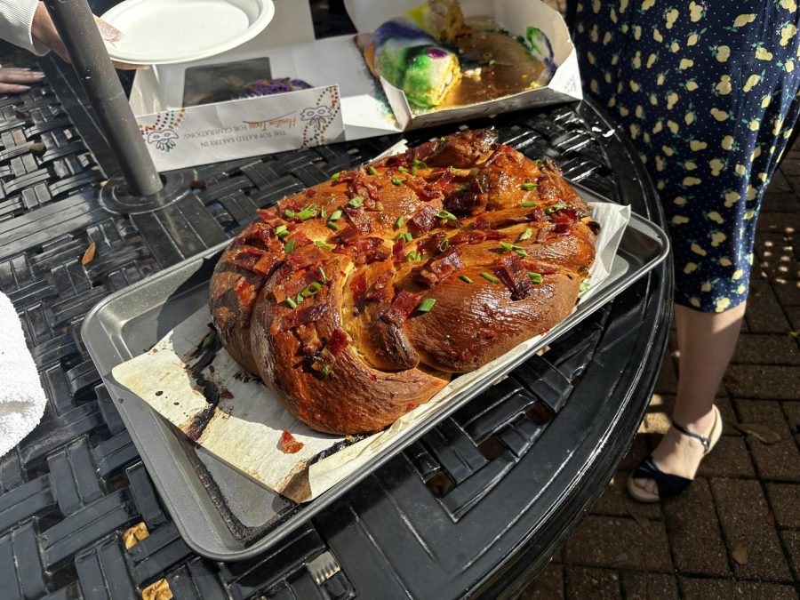 A half-eaten king cake sits behind a boudin-stuffed sausage cake served at a small outdoor festival held during “Cajun/Creole: A Little' Lagniappe, Cher." The class was taught by history and social sciences teacher Ms. Kristin Harrell during Interim Term.