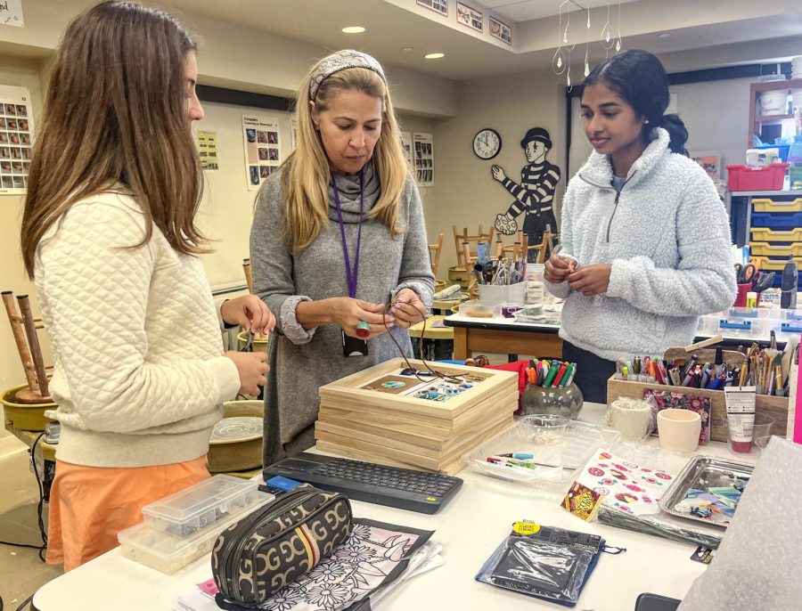 Ms. Luiza Grandchamp, Upper School visual arts teacher, helps sophomores Kate Hyman and Risha Neelapu make jewelry. Ms. Grandchamp taught "Art for Others" during Interim Term.