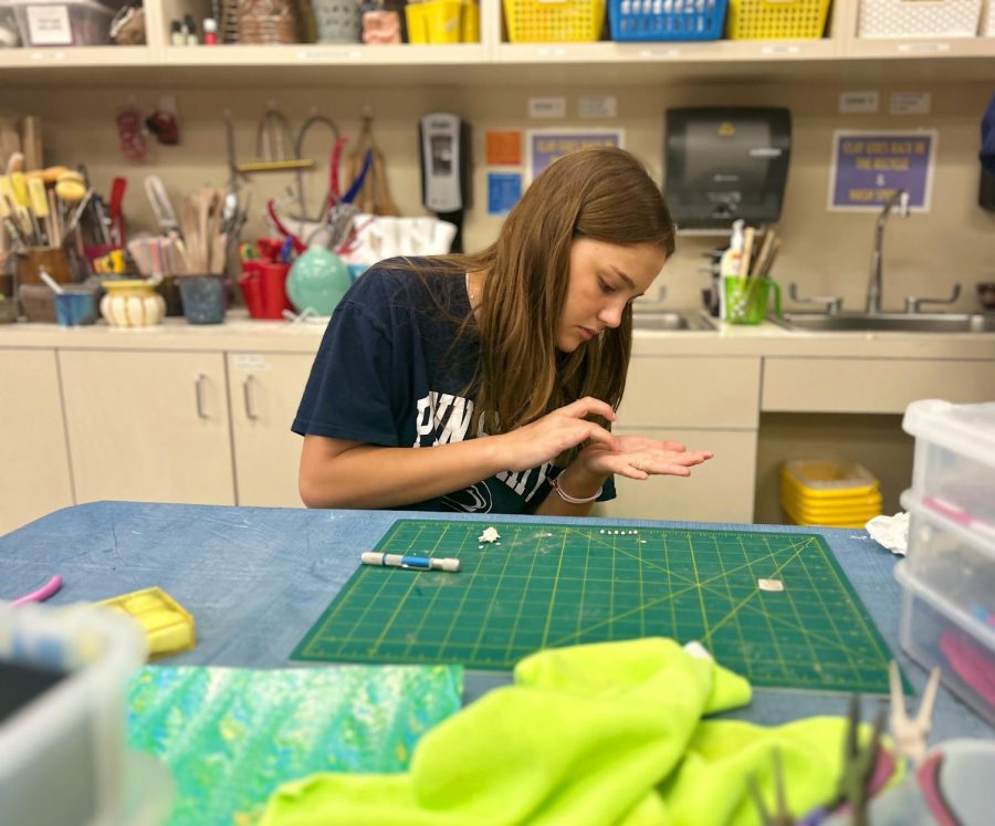 Ava Johnson, sophomore, starts the jewelry-making process by rolling out silver clay to imprint a design in her "Art for Others" Interim Term class. “I love 'Art for Others' because it is therapeutic and I enjoy giving back to the community,” she said.