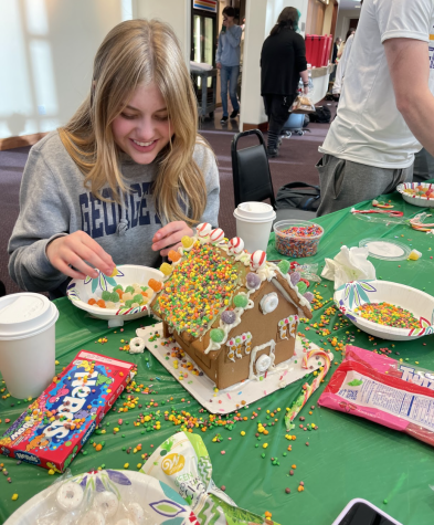 Junior Alexandra King builds her gingerbread house.