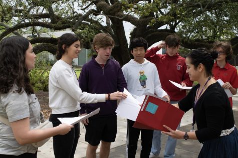 Upper School Latin teacher, Dr. Das, hands out guided assignments to her Latin 4 class; these packets are to be completed in the Menil Collection Cy Twombly exhibit.