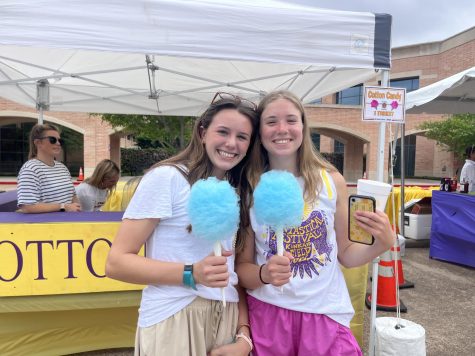 Sophomores Maddy Billipp and Haley Alexander smile with their cotton candy and other goods that they purchased with their tickets after the field day games. 