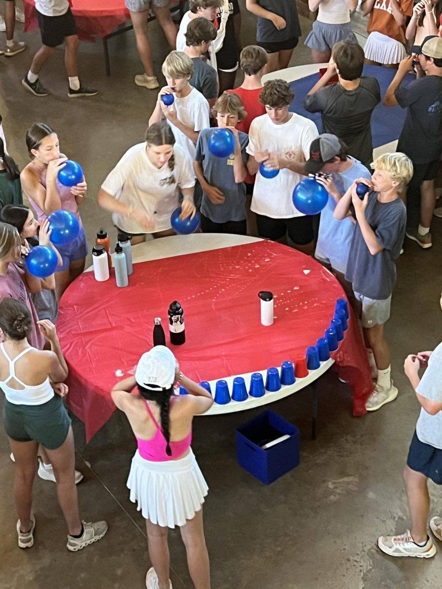 Community groups participated in a balloon cup activity. Students had to blow up balloons, then use the air from the inflated balloon to knock over cups.