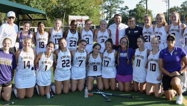 Head of School Mr. Jonathan Eades (fourth from right, back row) poses with the field hockey team and coaches after a victory against Episcopal High School.
