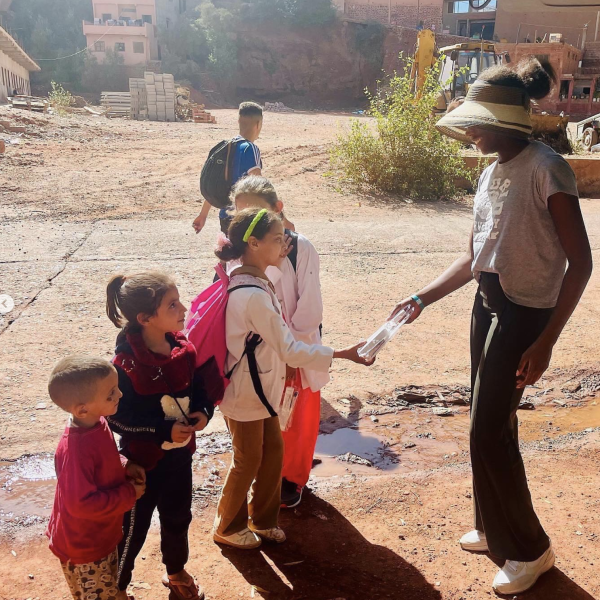 Sophomore Fife Famurewa (right) hands out care packages in the village of Ourika, which was affected by the earthquake in Morocco.