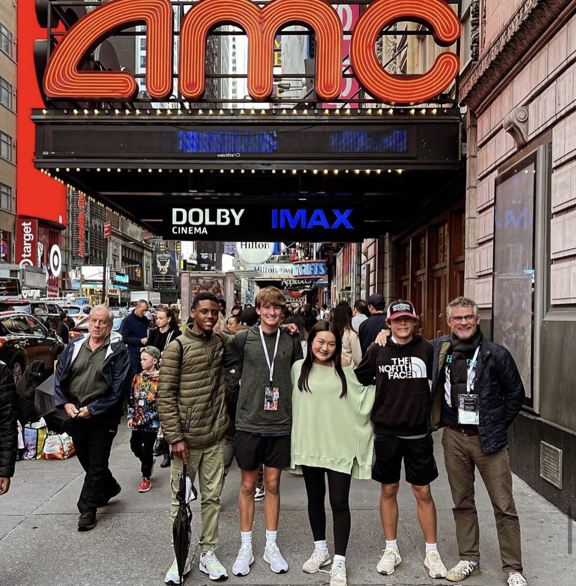 Freshmen stand outside the Times Square AMC at the All-American Film Festival.