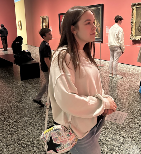Senior Audrey Brown examines large portraits by Titian and other Renaissance artists.