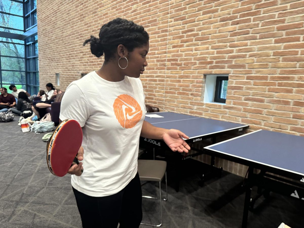 In the days leading up to the tournament, freshman ping pong participant Kaitlyn Manning mentally practices her ping pong serve in the Commons.
