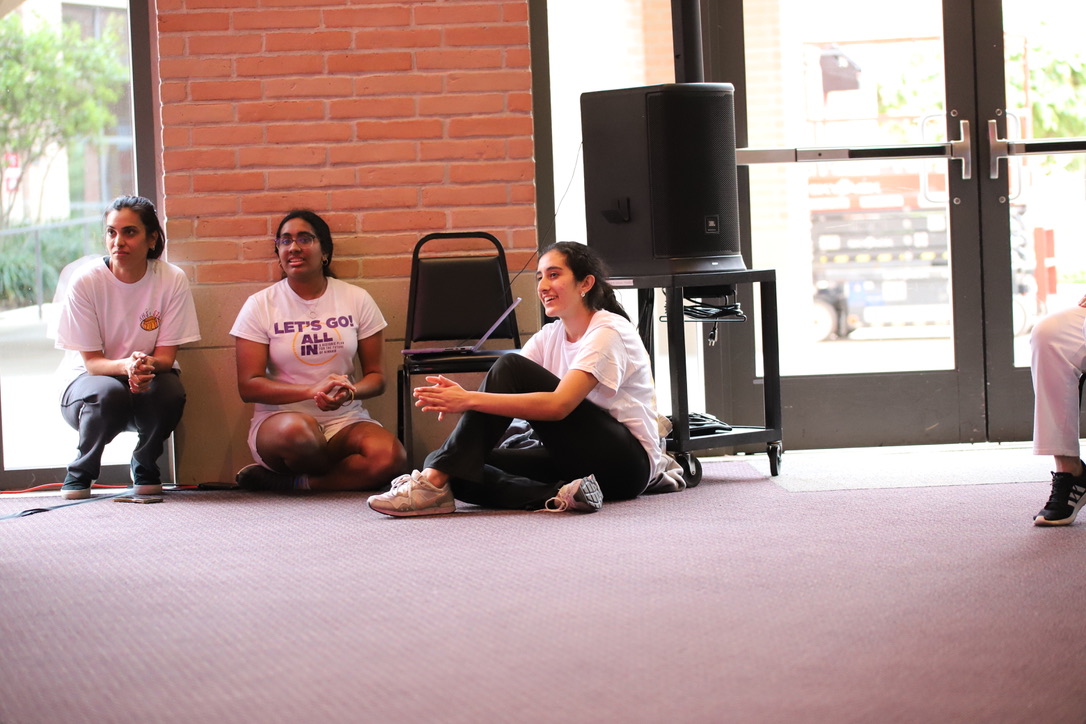 Dance teacher Ms. Anjaly Thakkar, sophomore Priyanka Nayar and senior Sanjna Pandit watch freshman Adi Kejriwal's performance during Holi-Basant.