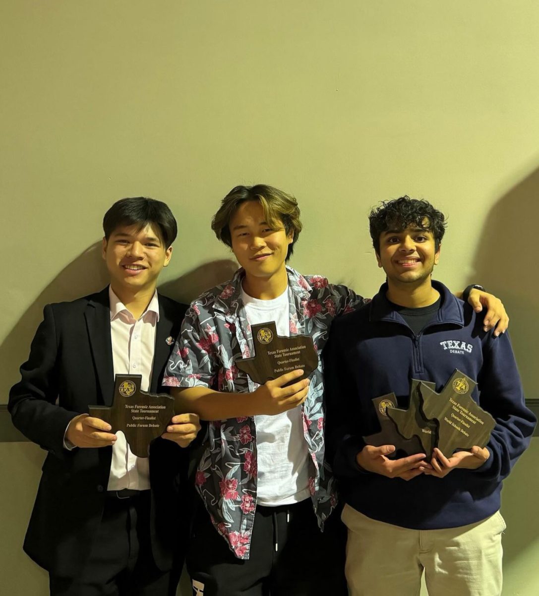 Senior Kaveen Shah and juniors Jason Zhang and Charlie Yang hold the awards they received for getting to the top eight of their respective divisions. 