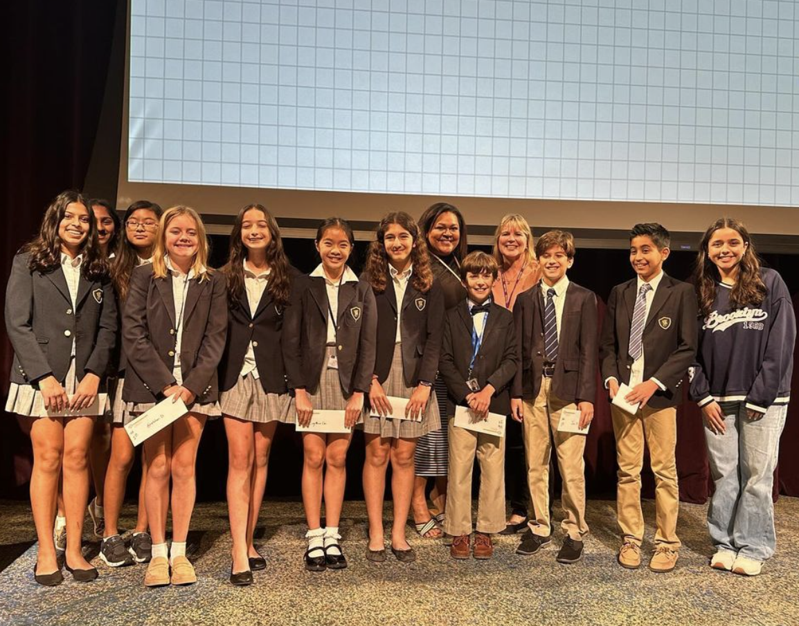 Shah (rightmost) stands with the winners of the Kinkaid Middle School science fair.