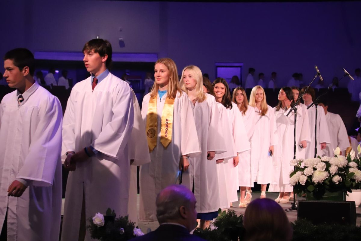 Seniors process across the stage of the Arena Theater during the baccalaureate ceremony.