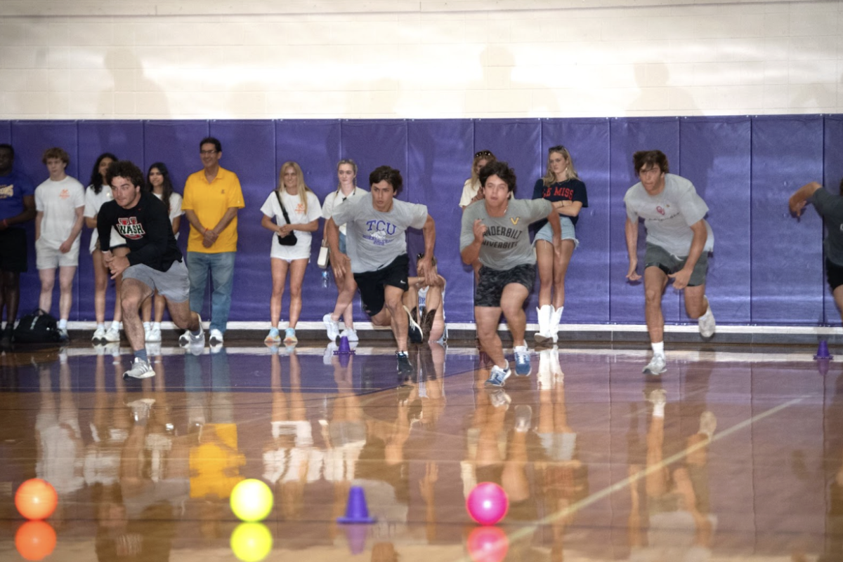 Students race to the center of the court at the start of the dodgeball finals.