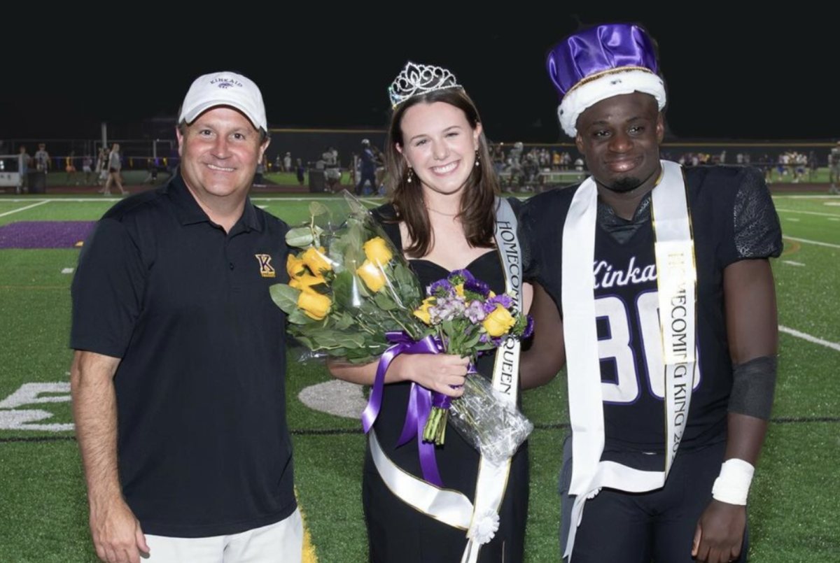  A photograph of the homecoming king, Gavin Johnson, and homecoming queen, Maddy Billip, with Mr. Eades after receiving their crowns and sashes. 