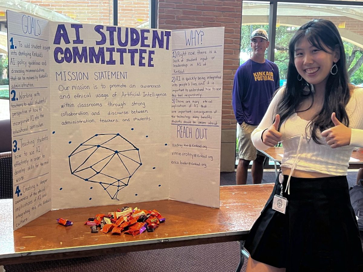 Sophomore Audrey Koo smiles with the committees' poster board at the student activity showcase.