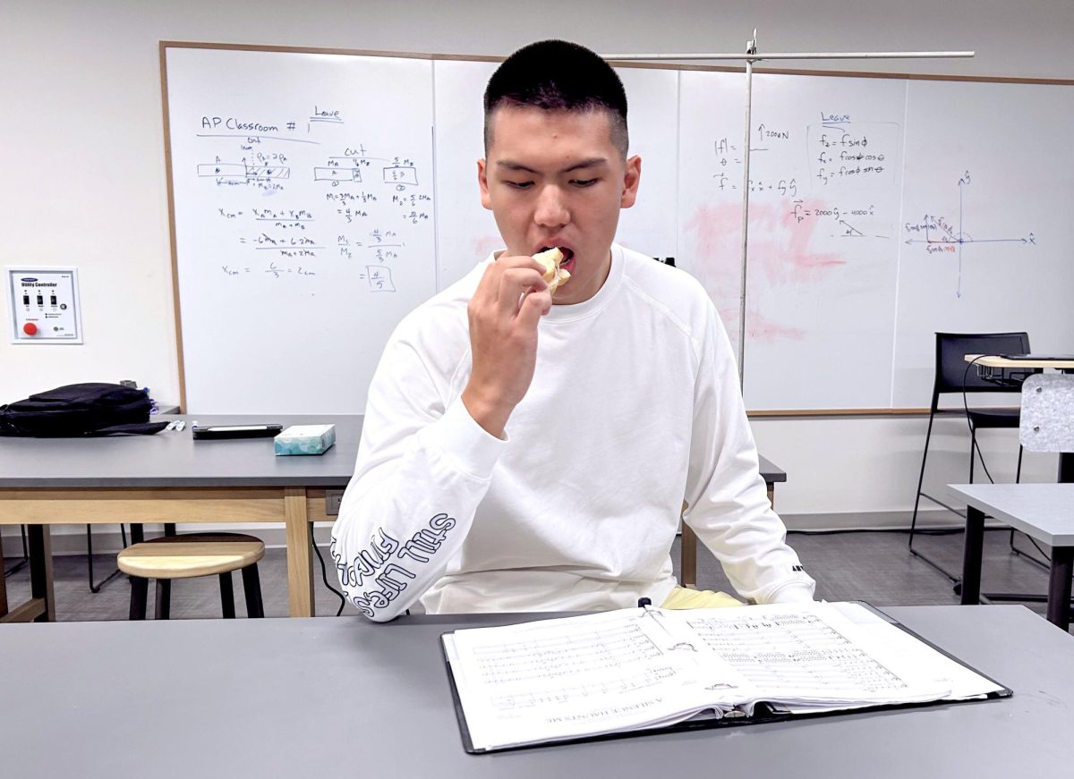 Jeremy Guo (12) enjoys his lunch while studying in his Physics classroom. As of Aug. 28, students are now able to eat within classrooms with the permission of teachers. “I’m happy that we can eat in class again; it allows for a lot more freedom in my school day,” Guo said.