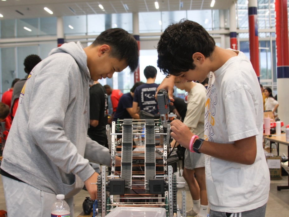 Freshmen Lucas Jiang and Ruhan Talreja work on finishing touches to the robot before the first match