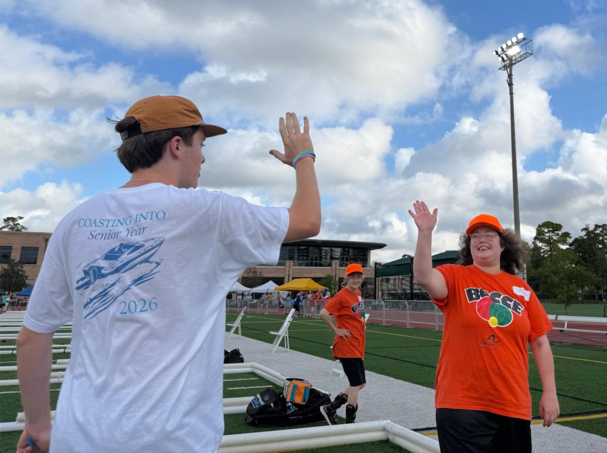 Senior Augie Pizack encourages athlete as she wins the round of bocce ball. Before the event started, volunteers were told to uplift the athletes. “Hyping up the athletes boosted my mood and it was great to see them proud,” said Pizack. 