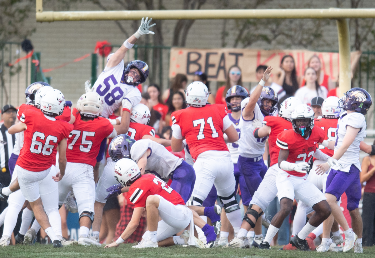 A Kinkaid defender leaps to block a kick during the rivalry game against St. John’s on Nov. 3 at St. John’s School. The Falcons won 38–14 in their first matchup away from Rice Stadium in 45 years.