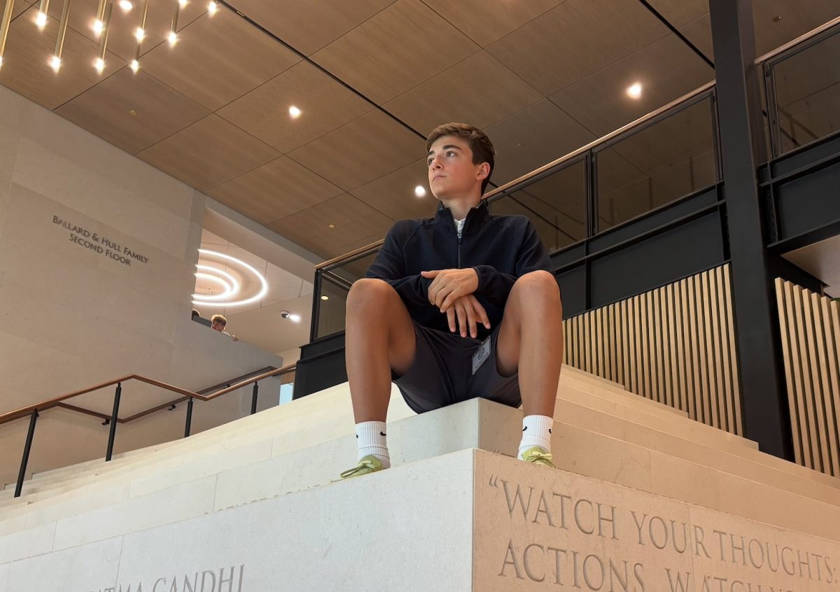 Freshman Max Warner takes a seat on the Social Stairs in the new Bowden Upper School Lobby. “Sometimes when I'm feeling kind of down, just going to the steps and thinking clears my mind,” Warner said.
