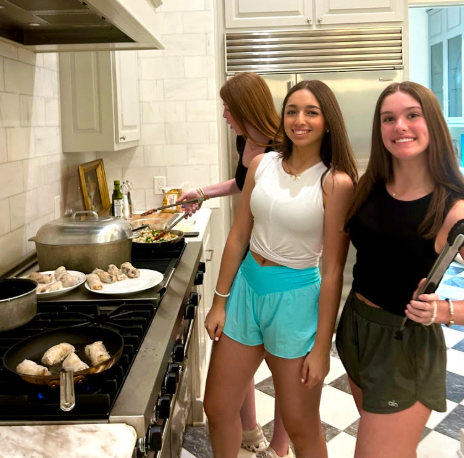 Juniors Olivia Utterback, Lara Alp and Sadie Ferber cook vegetable spring rolls, dumplings and chicken fried rice for the first time.