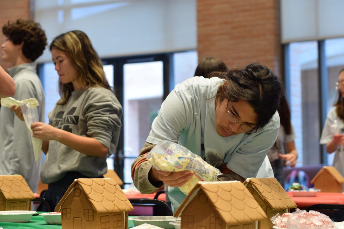 Senior Charlie Assiff and other members of the Fine Arts Leadership Board set up gingerbread houses for an edible holiday village event. The board meets twice a month during Upper School lunch. Members take on a wide range of responsibilities, from working front of house at performances to helping run concessions, tickets, gallery receptions and department events.